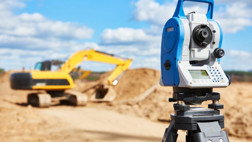 Theodolite with an Excavator in the background.