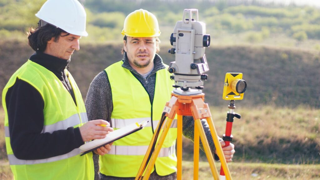 Two man doing a boundary survey.