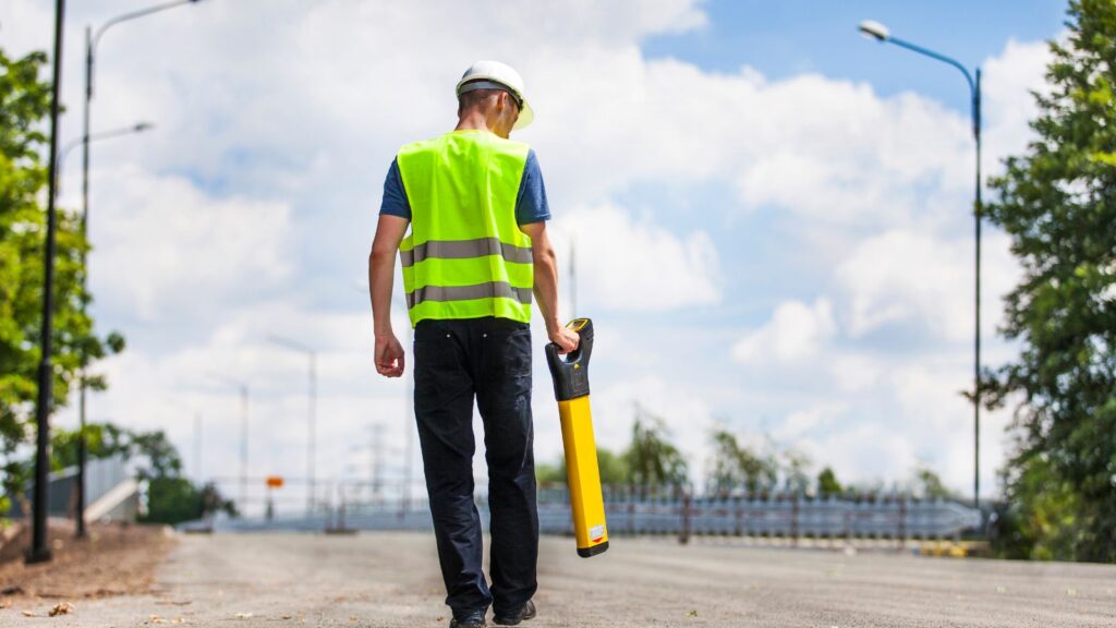 Professional Surveyor holding a tool.